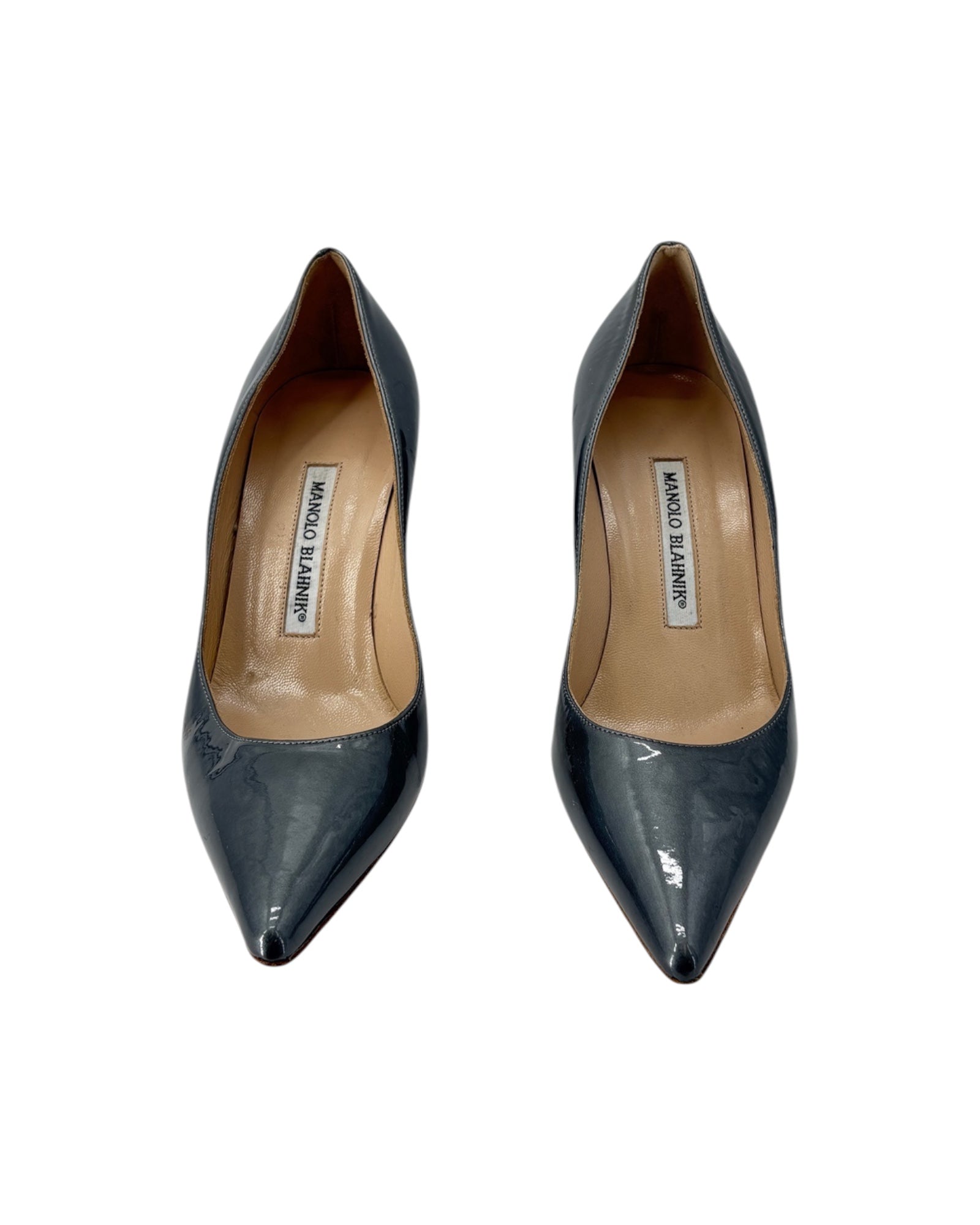 Pair of Silver pointed-toe shoes with brand label on a white background