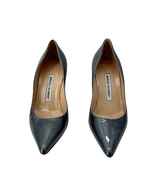 Pair of Silver pointed-toe shoes with brand label on a white background