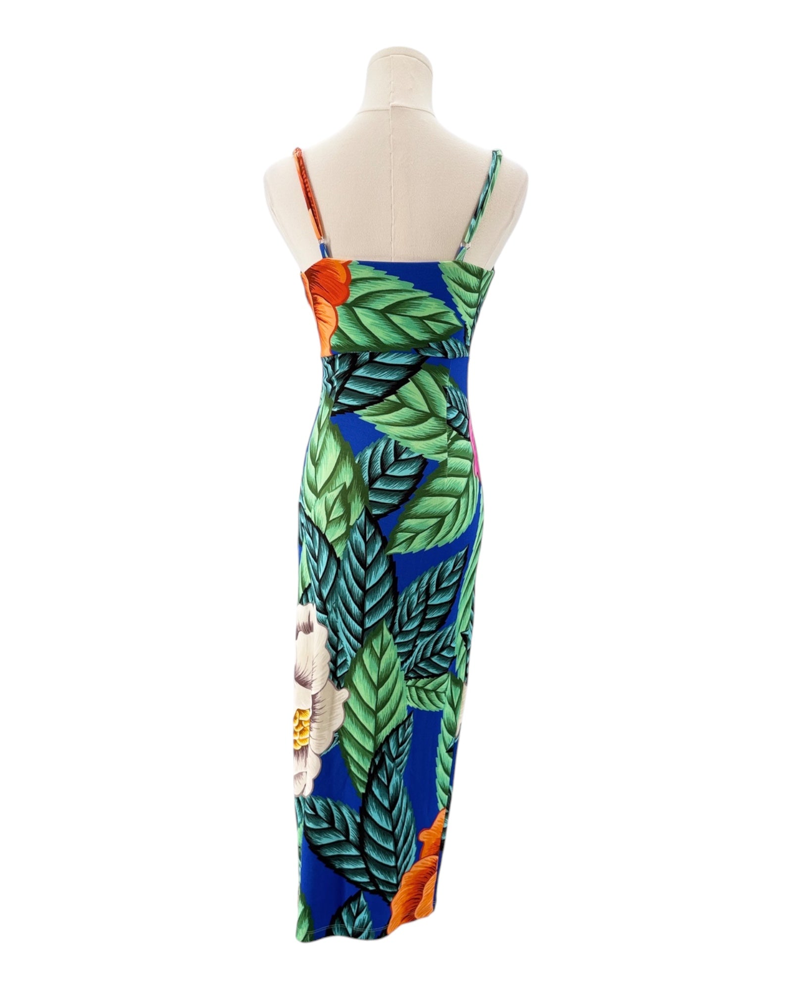 Colorful dress with leaf pattern on a mannequin against a white background