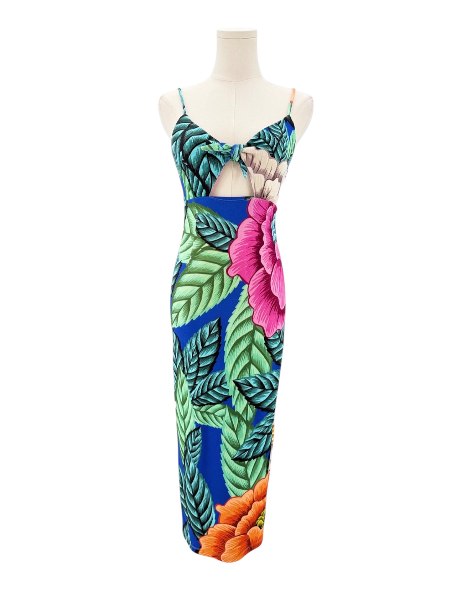 Colorful floral dress on a mannequin against a white background