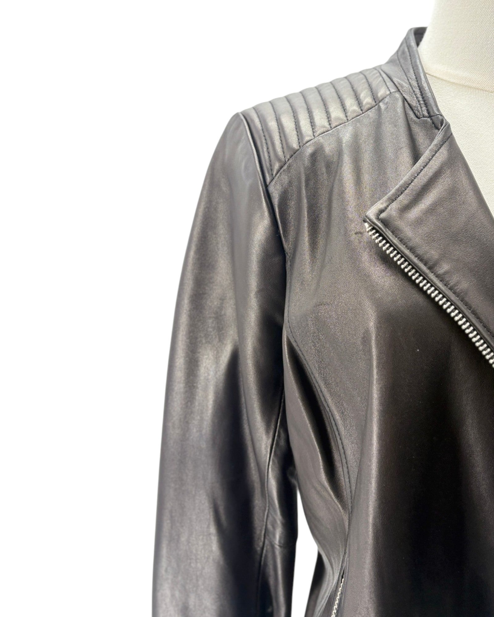 black leather jacket on a mannequin against a white background
