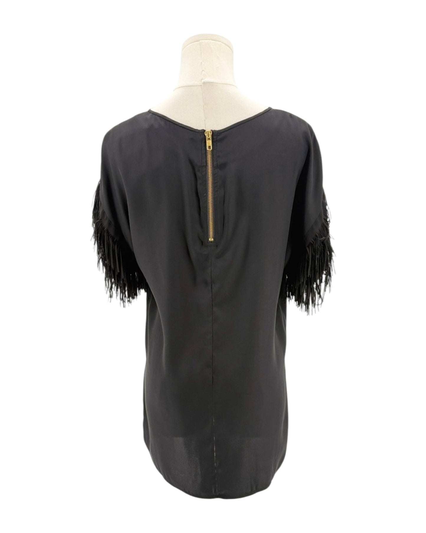 Black top with fringe sleeves on a mannequin against a white background