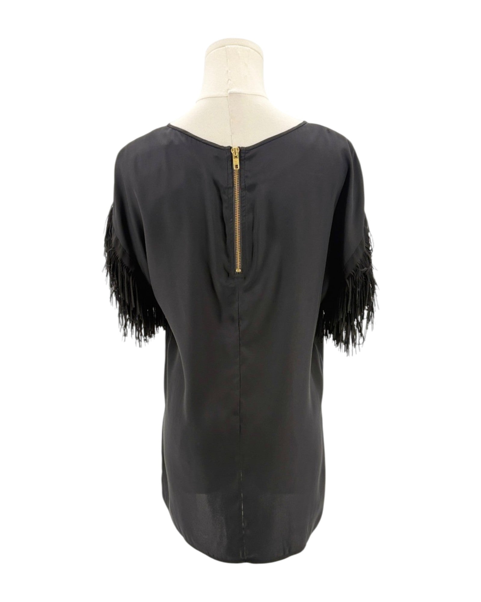 Black top with fringe sleeves on a mannequin against a white background