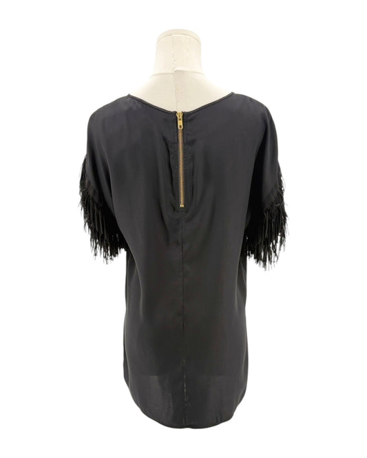 Black top with fringe sleeves on a mannequin against a white background