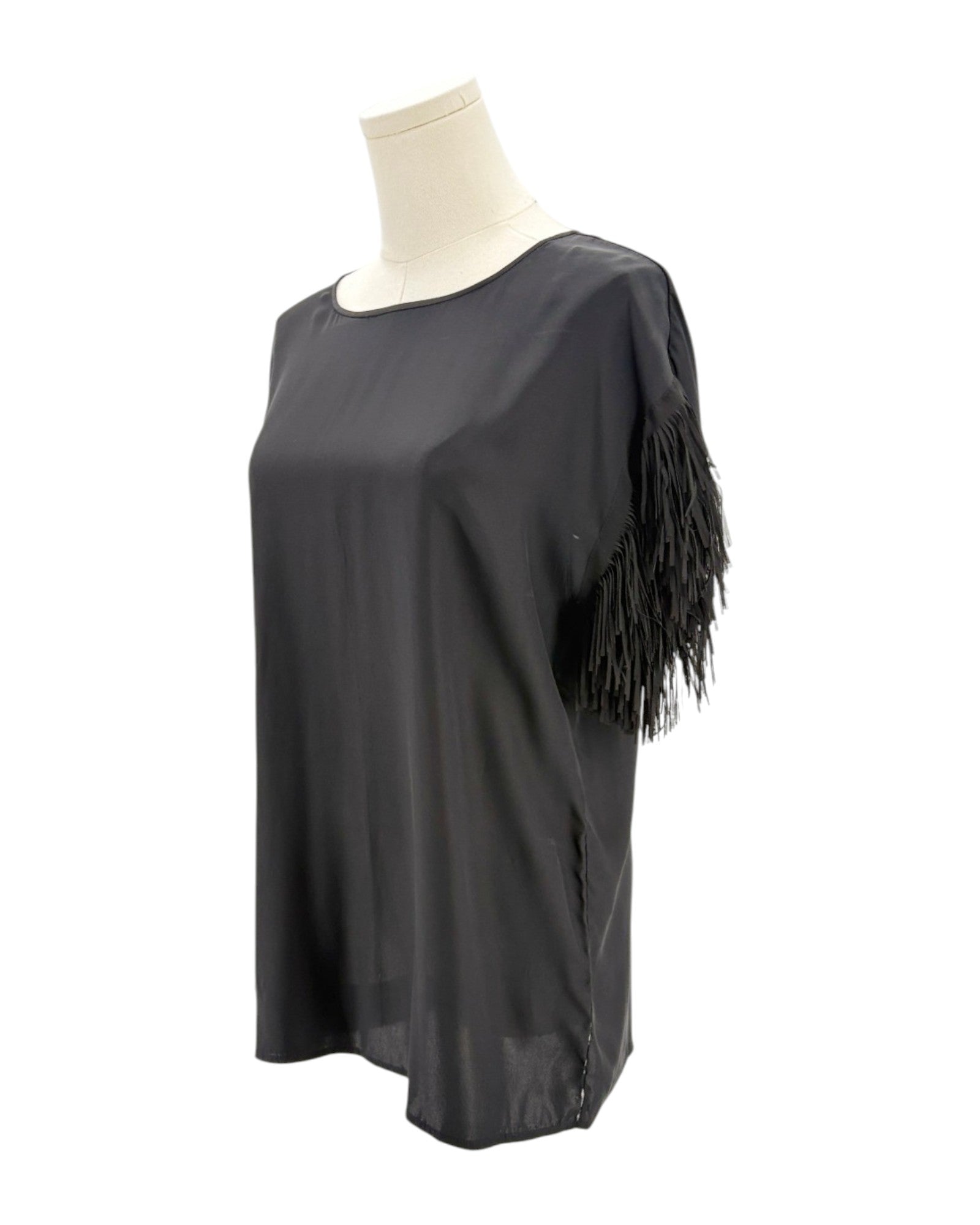 Black fringe top on a mannequin against a white background