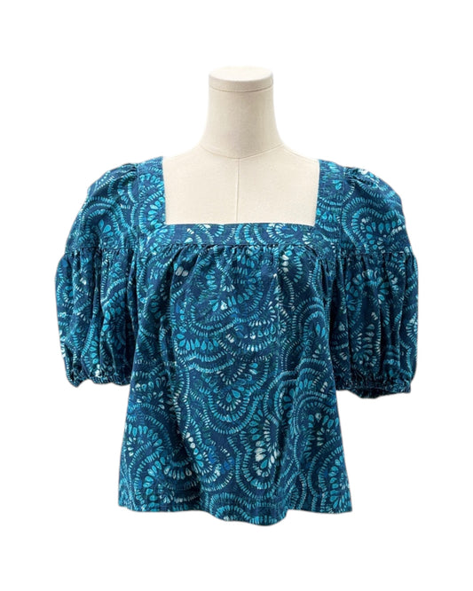 Blue patterned blouse on a mannequin against a white background