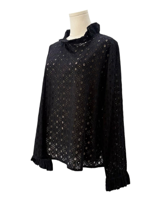 Black blouse with eyelet fabric on a mannequin against a white background