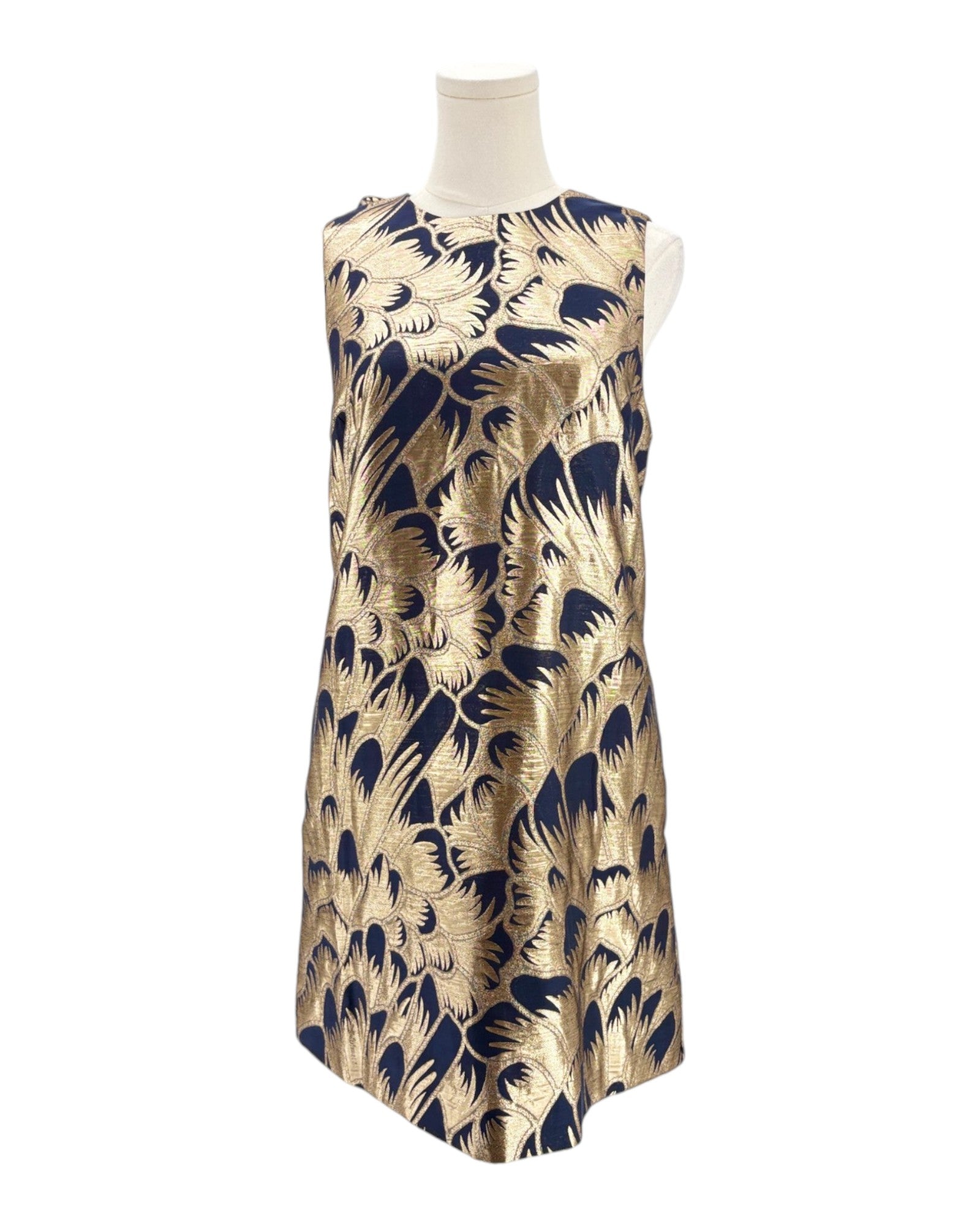Gold and navy patterned dress on a mannequin against a white background