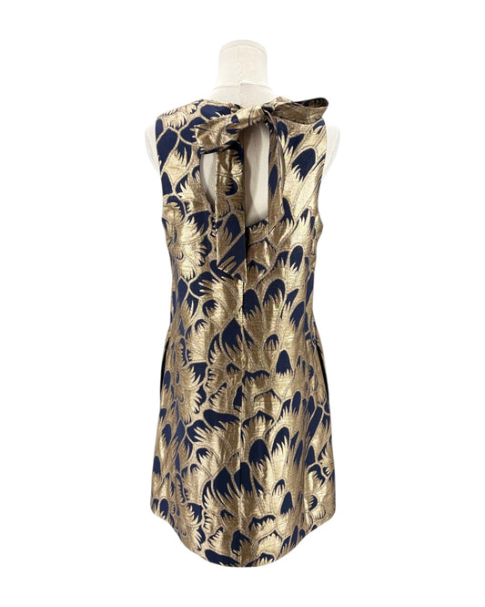 Gold and navy patterned dress on a mannequin against a white background