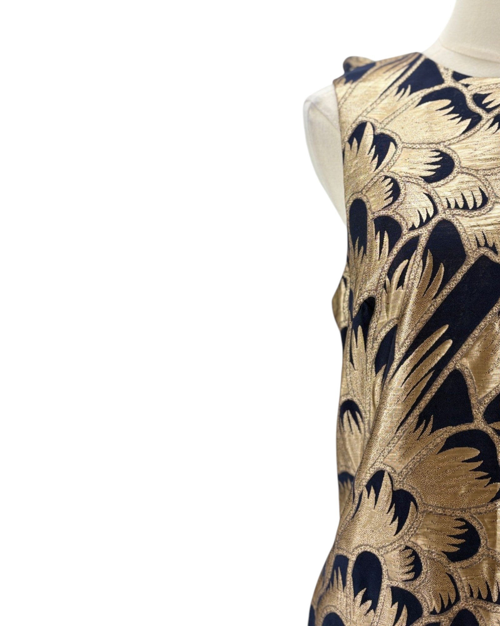Mannequin wearing a dress with gold and navy floral pattern on a white background