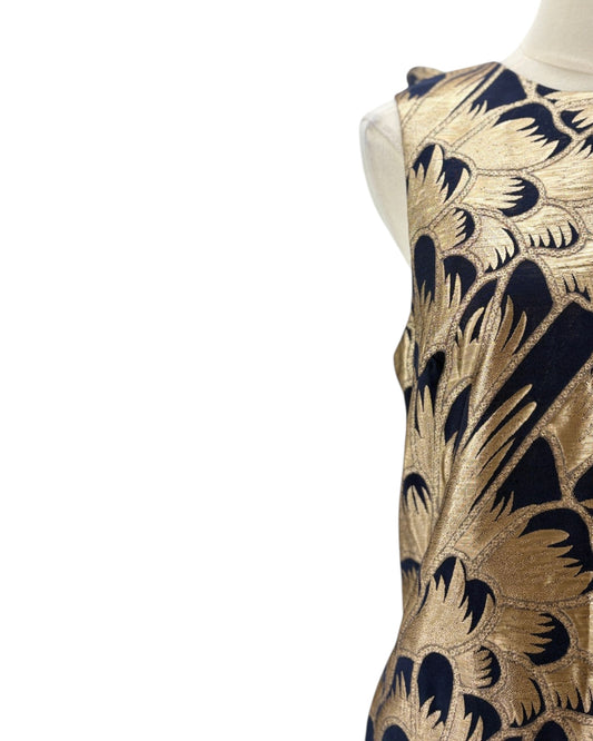 Mannequin wearing a dress with gold and navy floral pattern on a white background