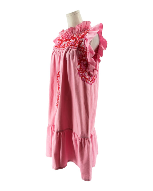 Pink dress with floral details on a mannequin against a white background