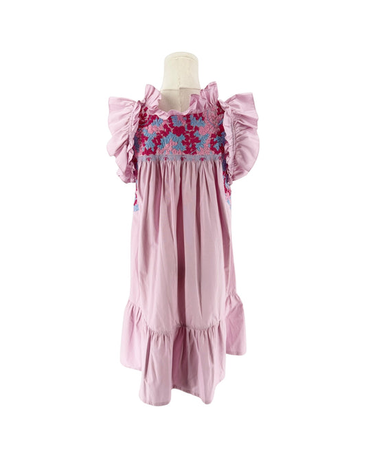 A pink smocked mini dress with ruffled sleeves and a colorful floral smocked bodice, displayed on a mannequin against a white background. 