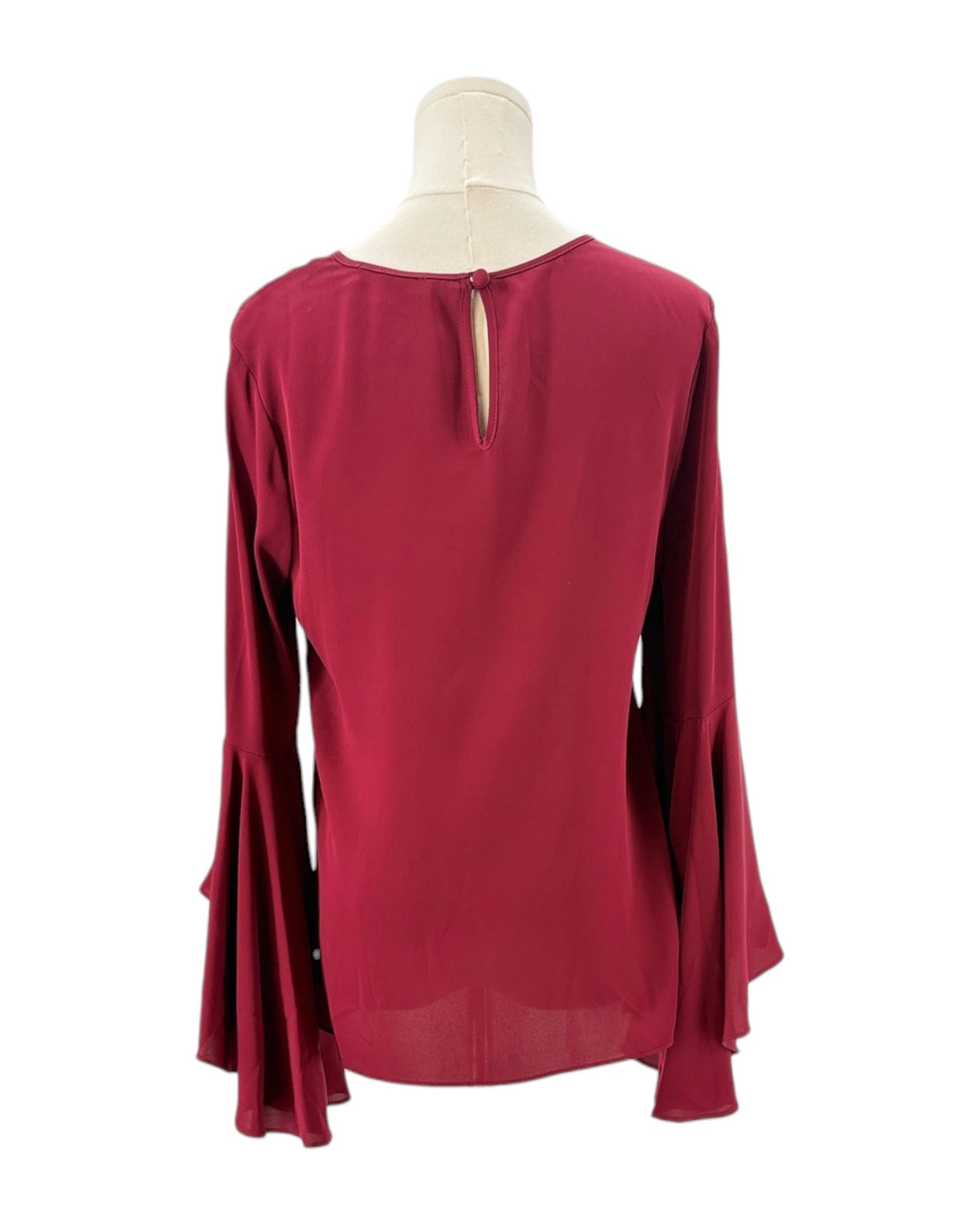 Red blouse on a mannequin with a white background