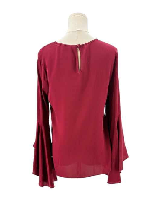 Red blouse on a mannequin with a white background