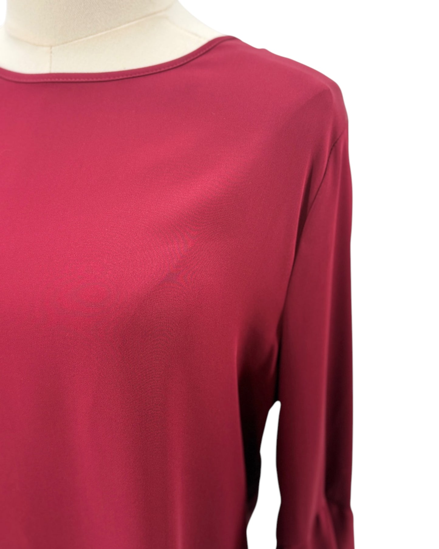 Maroon long-sleeve top on a mannequin with a white background