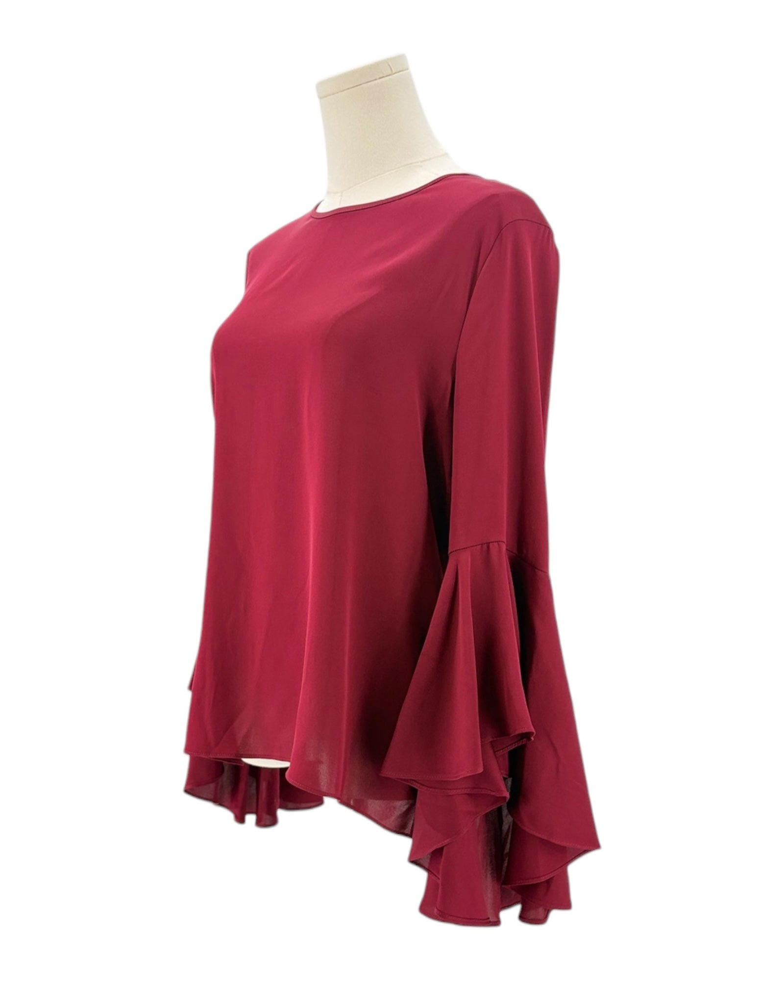 Red blouse with ruffled sleeves on a mannequin against a white background