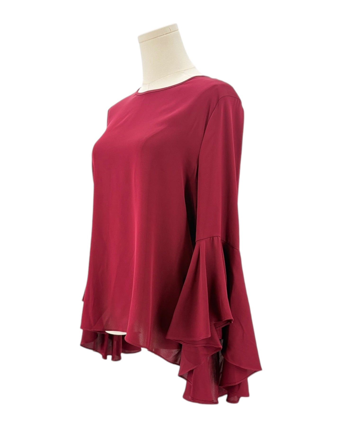 Red blouse with ruffled sleeves on a mannequin against a white background