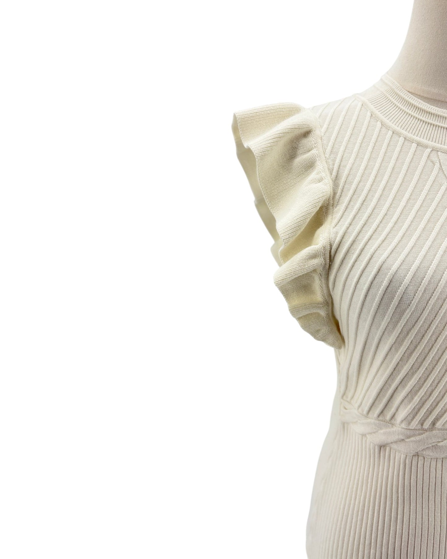 Close-up of a ribbed knit sleeveless top with ruffled shoulders on a white background