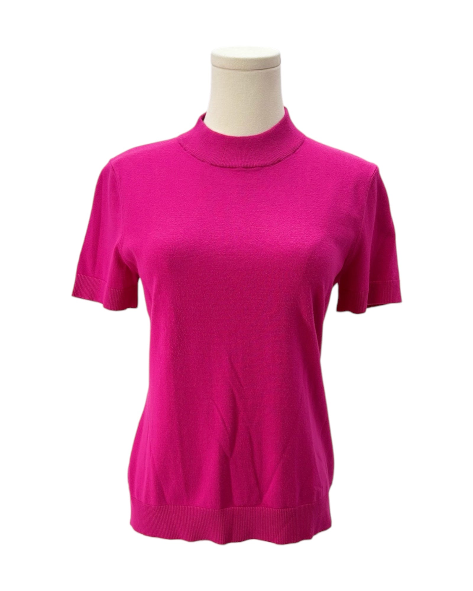Pink turtleneck sweater on a mannequin against a white background