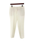 Cream colored trousers on a white background