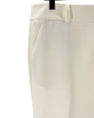 Cream colored trousers on a white background