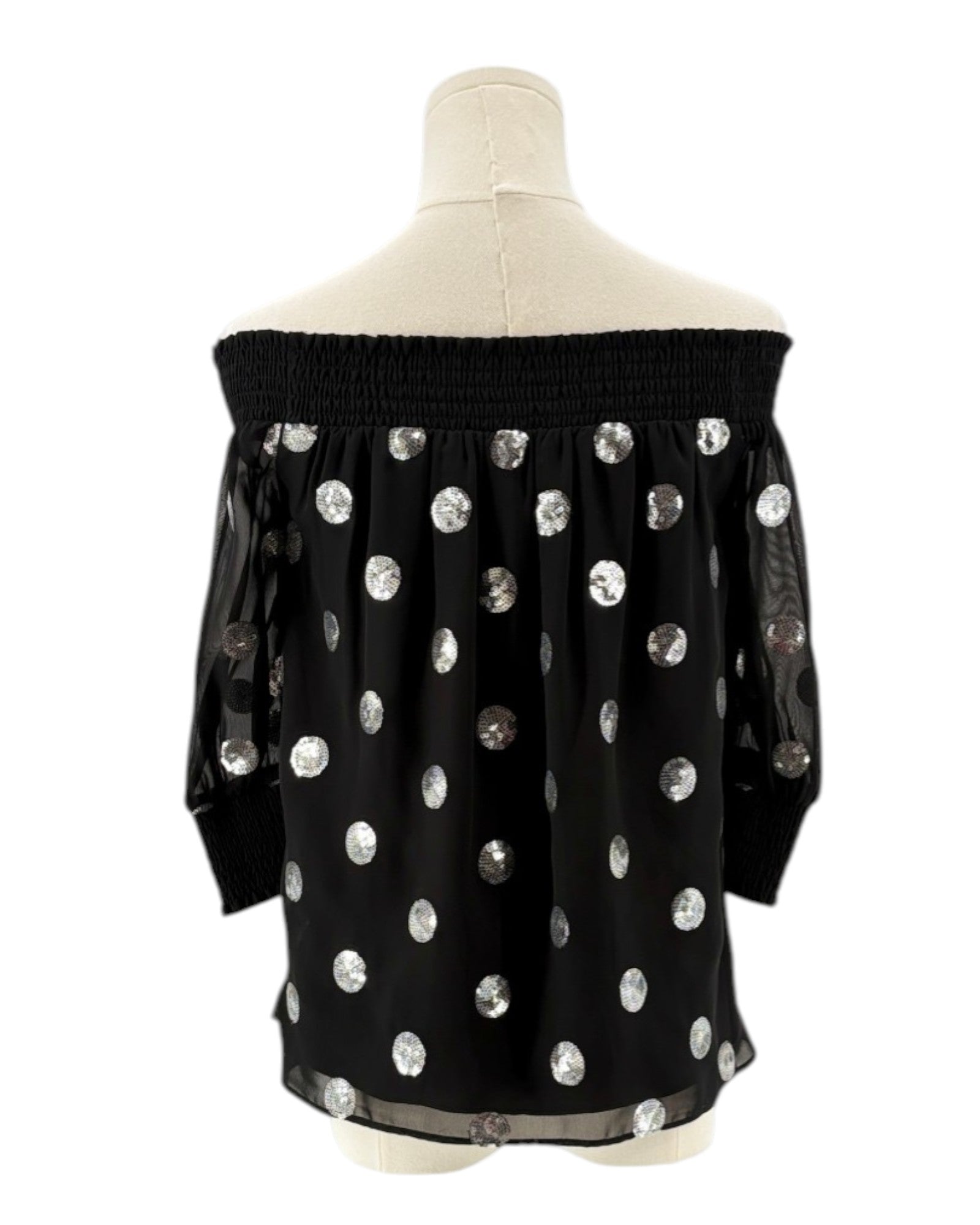 Milly black off-shoulder top with silver sequin polka dots on a mannequin against a white background