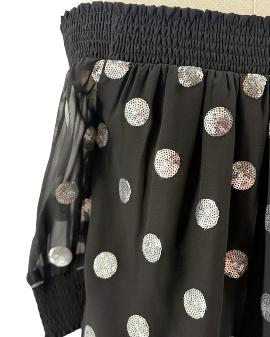 Milly black off-shoulder top with silver sequin polka dots on a mannequin against a white background