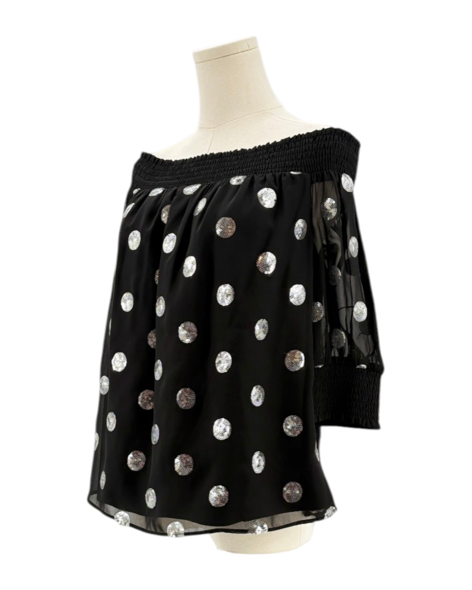 Milly black off-shoulder top with silver sequin polka dots on a mannequin against a white background
