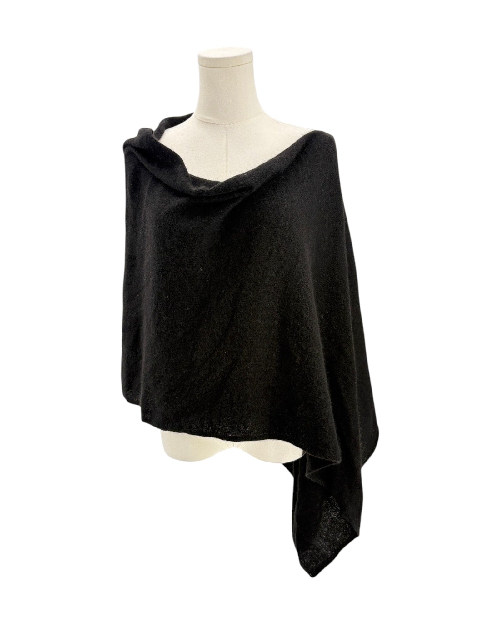 Black poncho on a mannequin against a white background