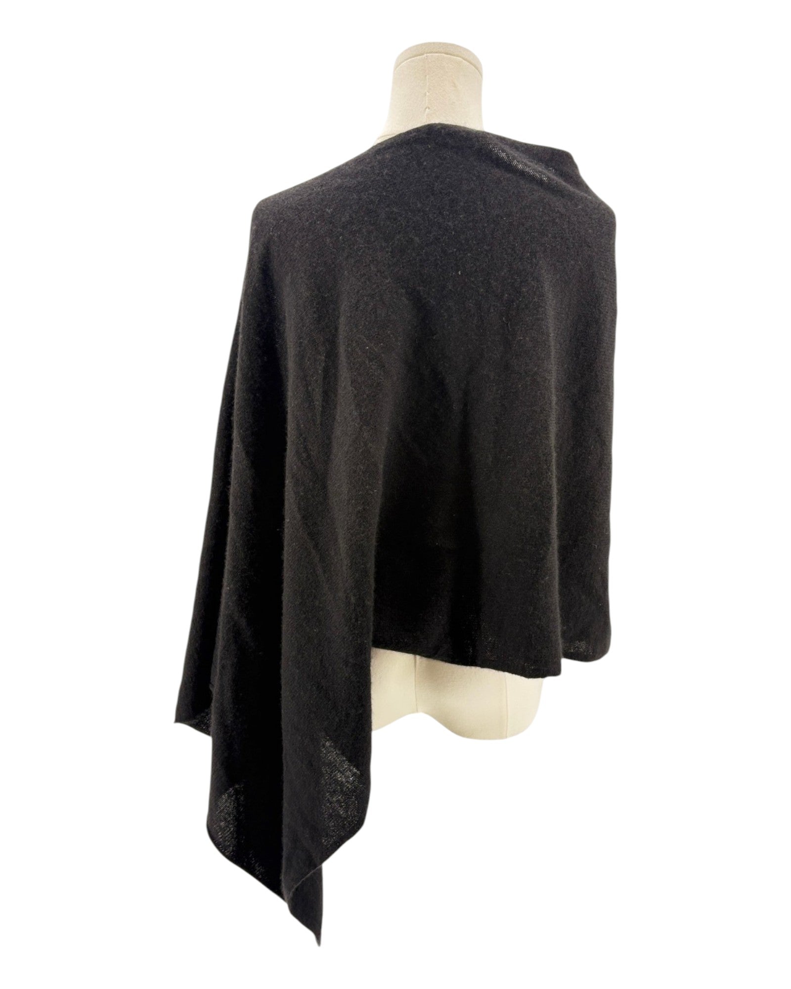 Black poncho on a mannequin against a white background