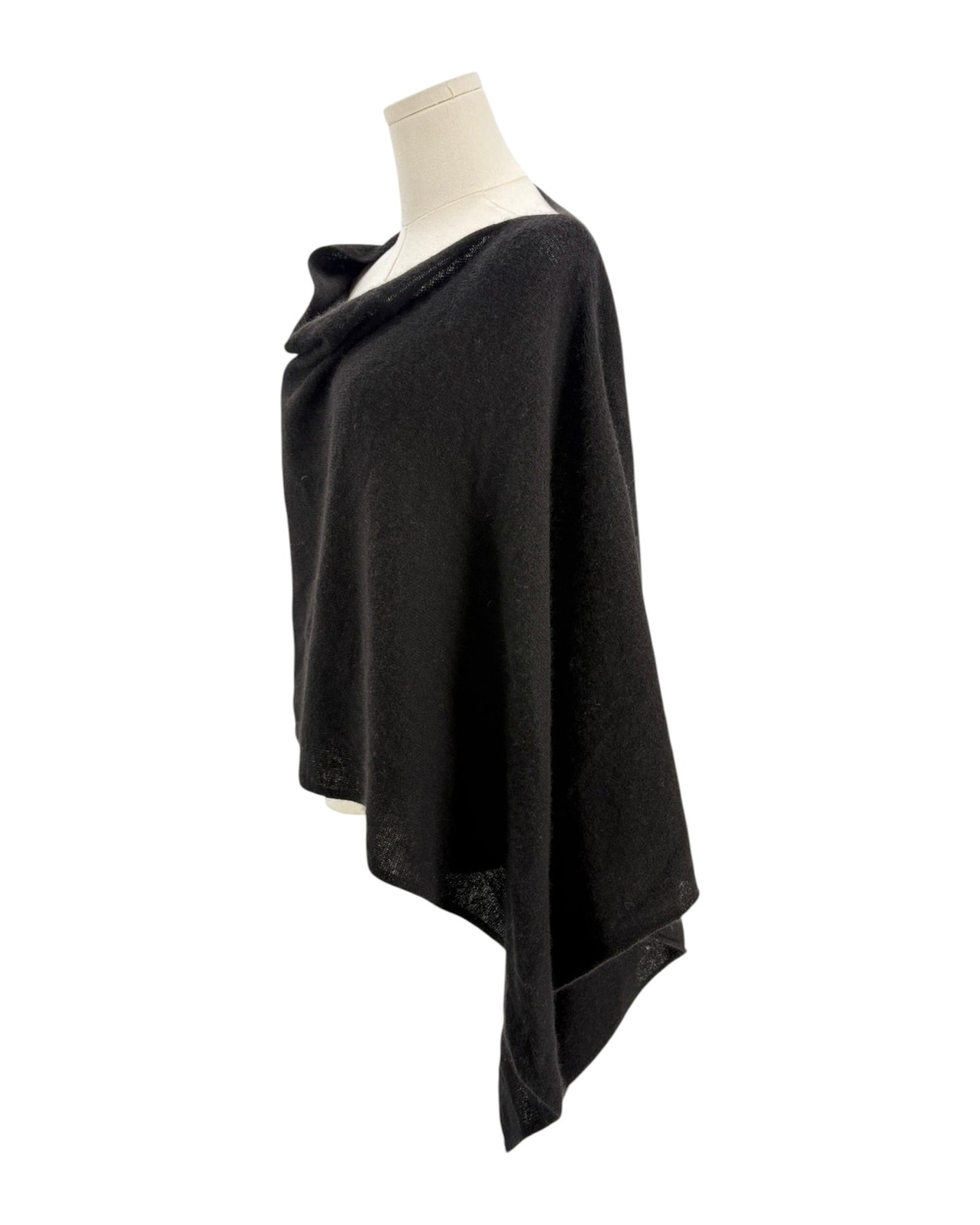 Black poncho on a mannequin against a white background