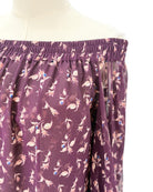 Purple top with a floral pattern on a mannequin against a white background