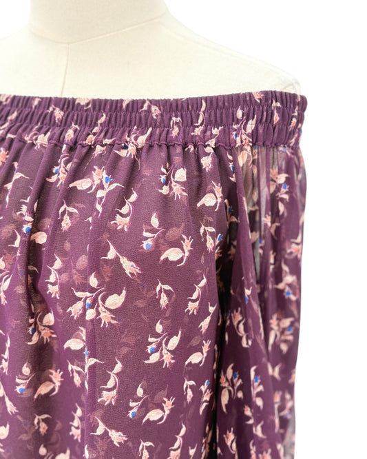 Purple top with a floral pattern on a mannequin against a white background