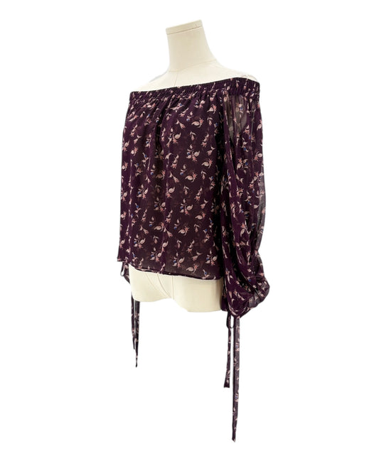 Purple floral off-shoulder blouse on a mannequin against a white background