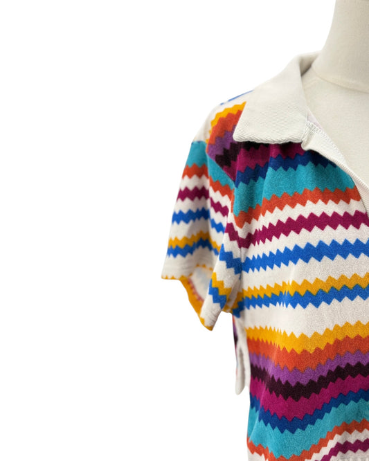 Colorful striped sweater on a mannequin against a white background