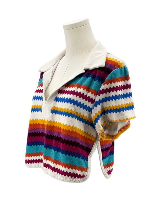 Colorful striped sweater on a mannequin against a white background