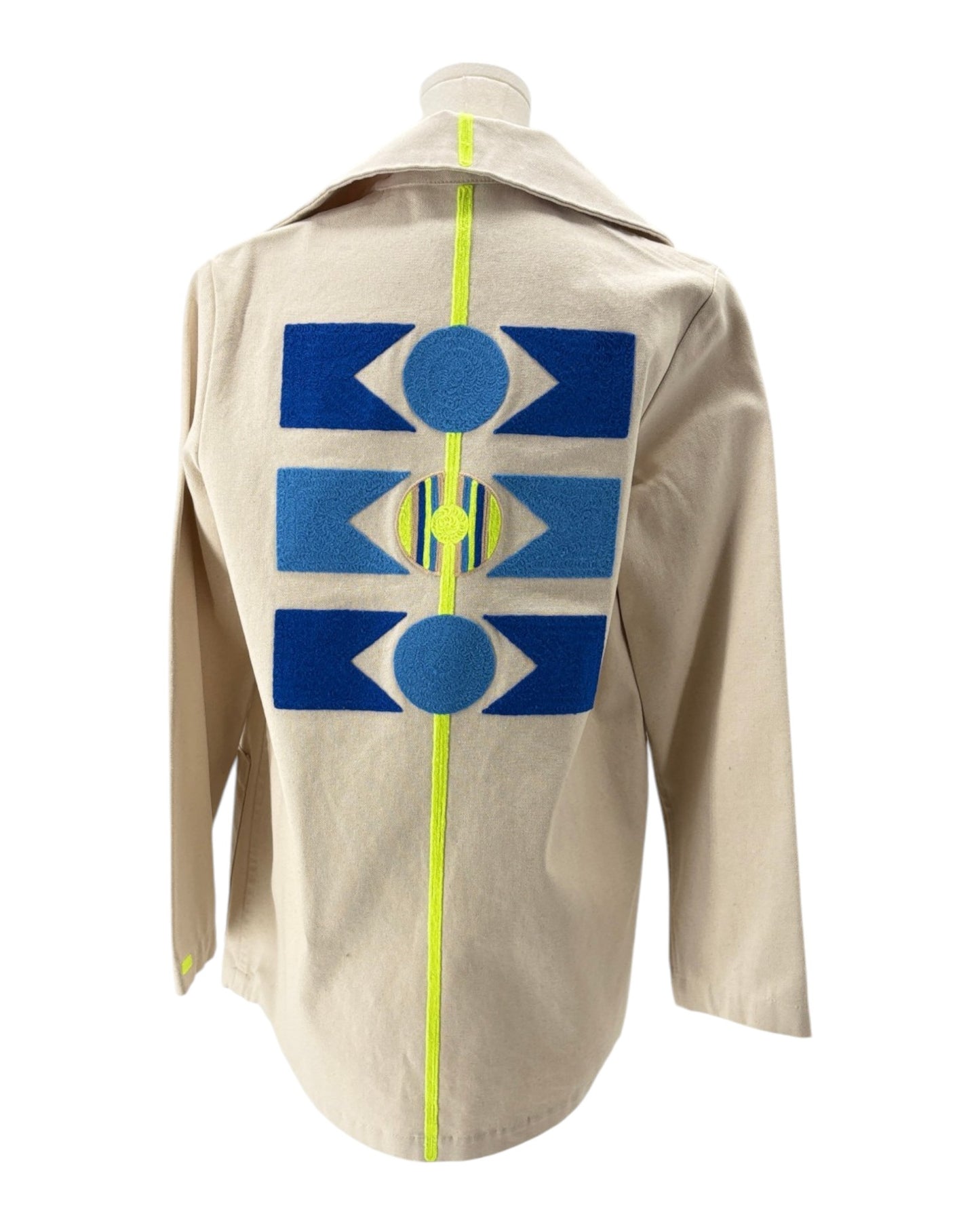 Beige jacket with blue geometric patterns on the back against a white background