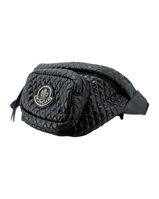 Black quilted waist bag with a brand logo on a white background