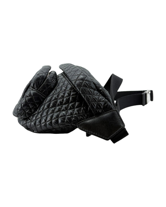 Black quilted leather glove with a strap on a white background