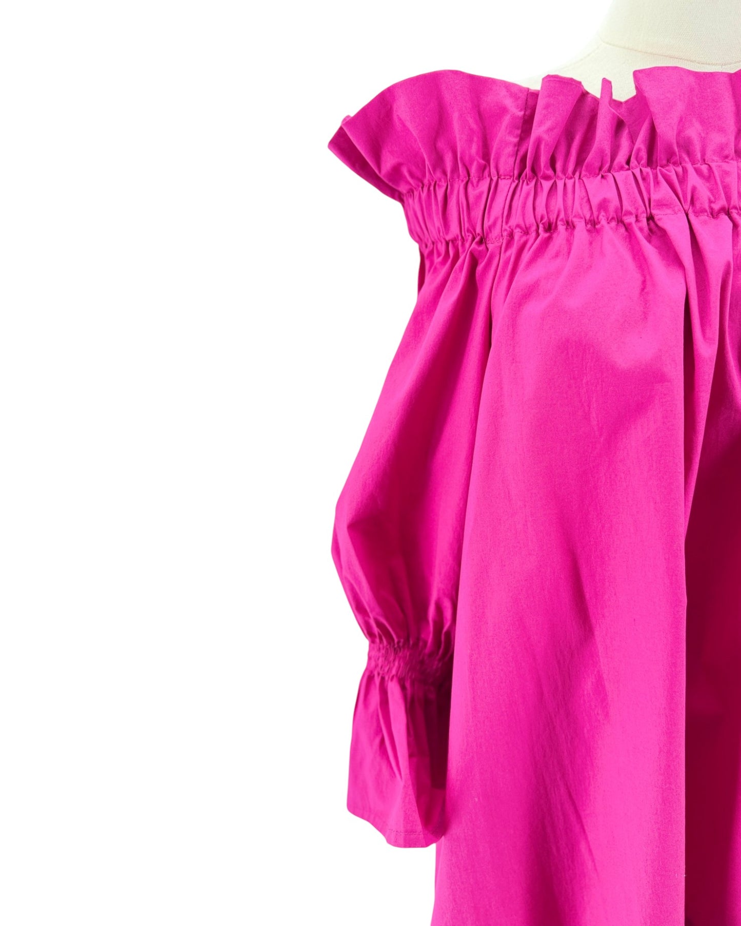 Close-up of a bright pink off-shoulder top on a white background