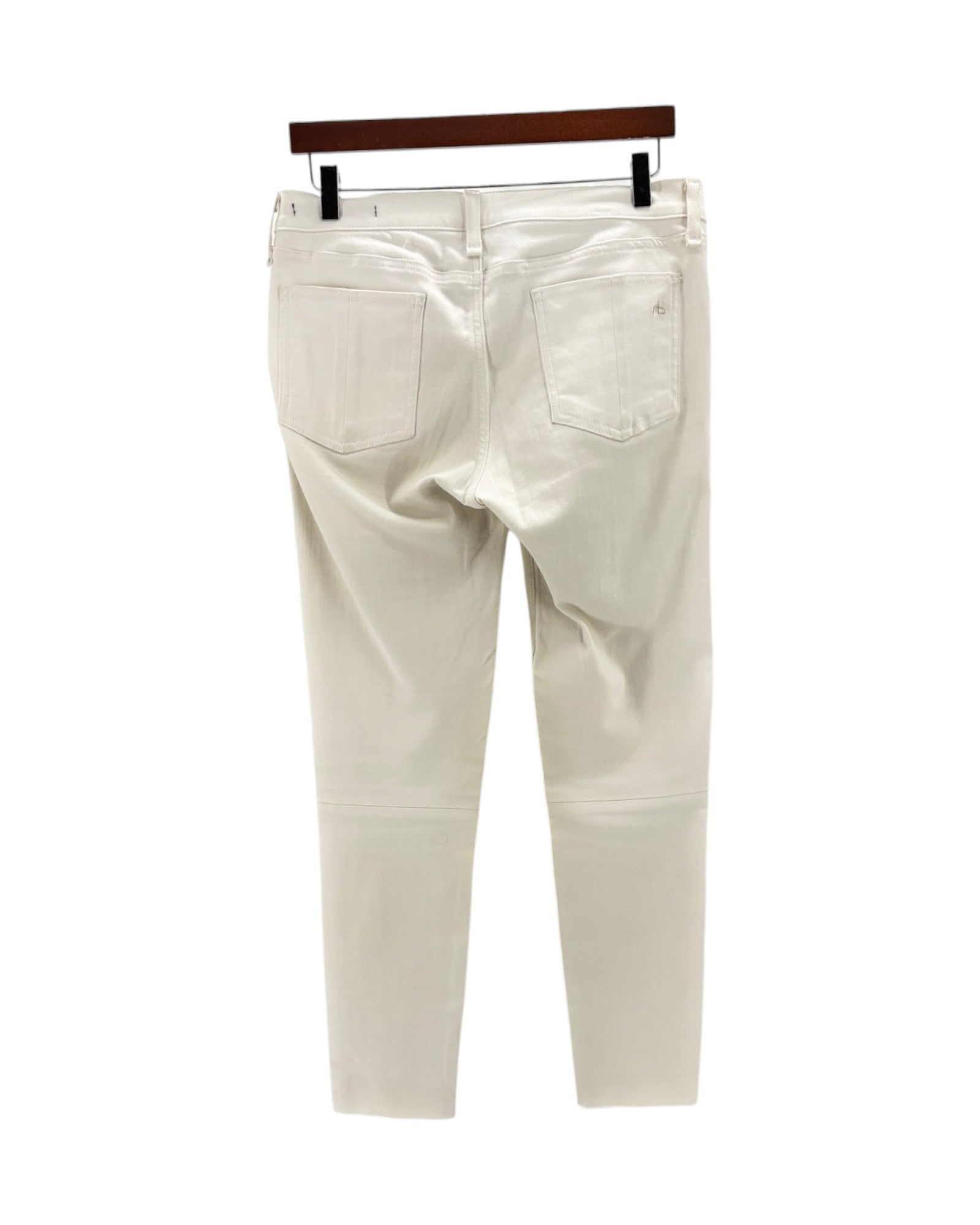 White pants on a hanger against a white background