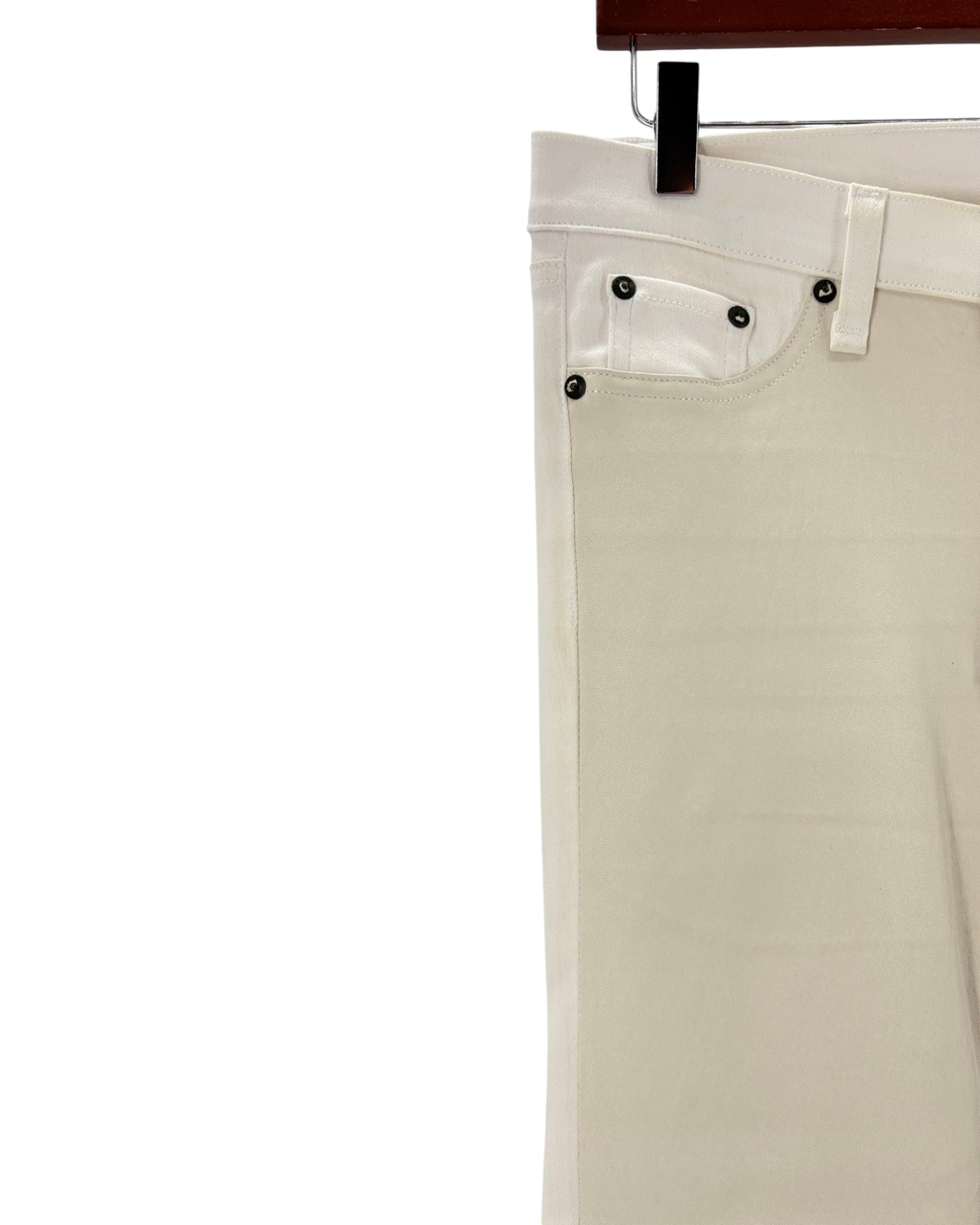 Beige pants hanging on a white background
