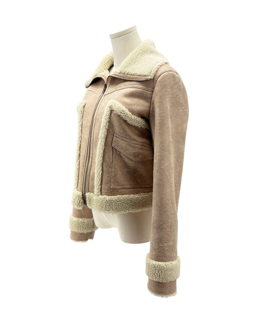 Beige shearling jacket on a mannequin against a white background