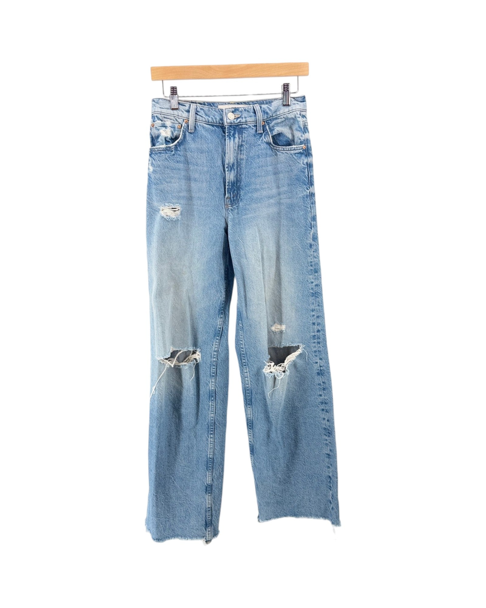 Light wash blue distressed jeans with ripped details on the thighs and knees, hanging from a wooden hanger against a plain white background.
