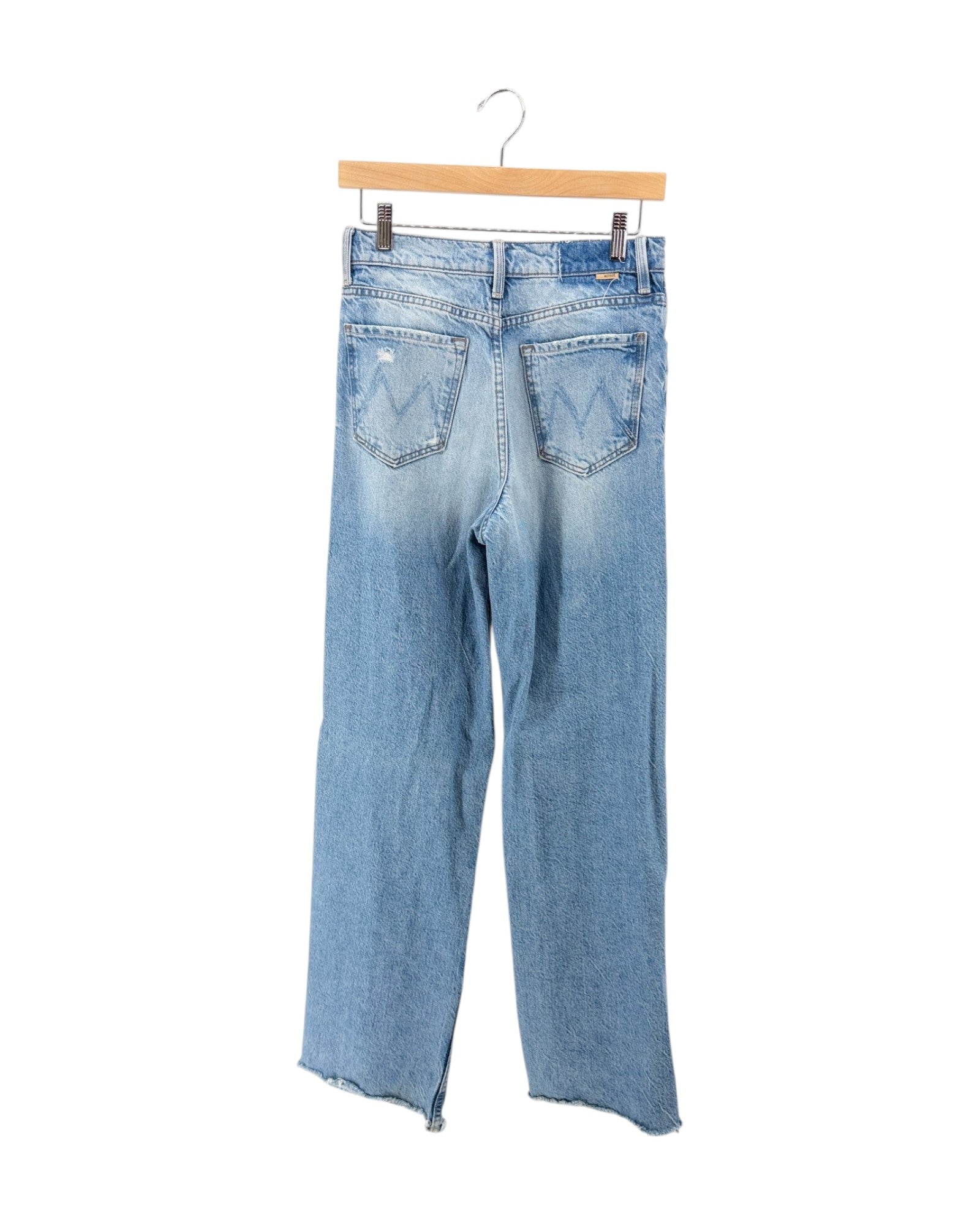 Light blue denim jeans shown from the back, hanging from a wooden hanger against a plain white background.