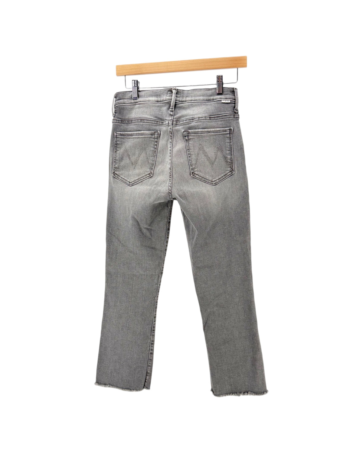 Gray denim jeans on a hanger on a white background