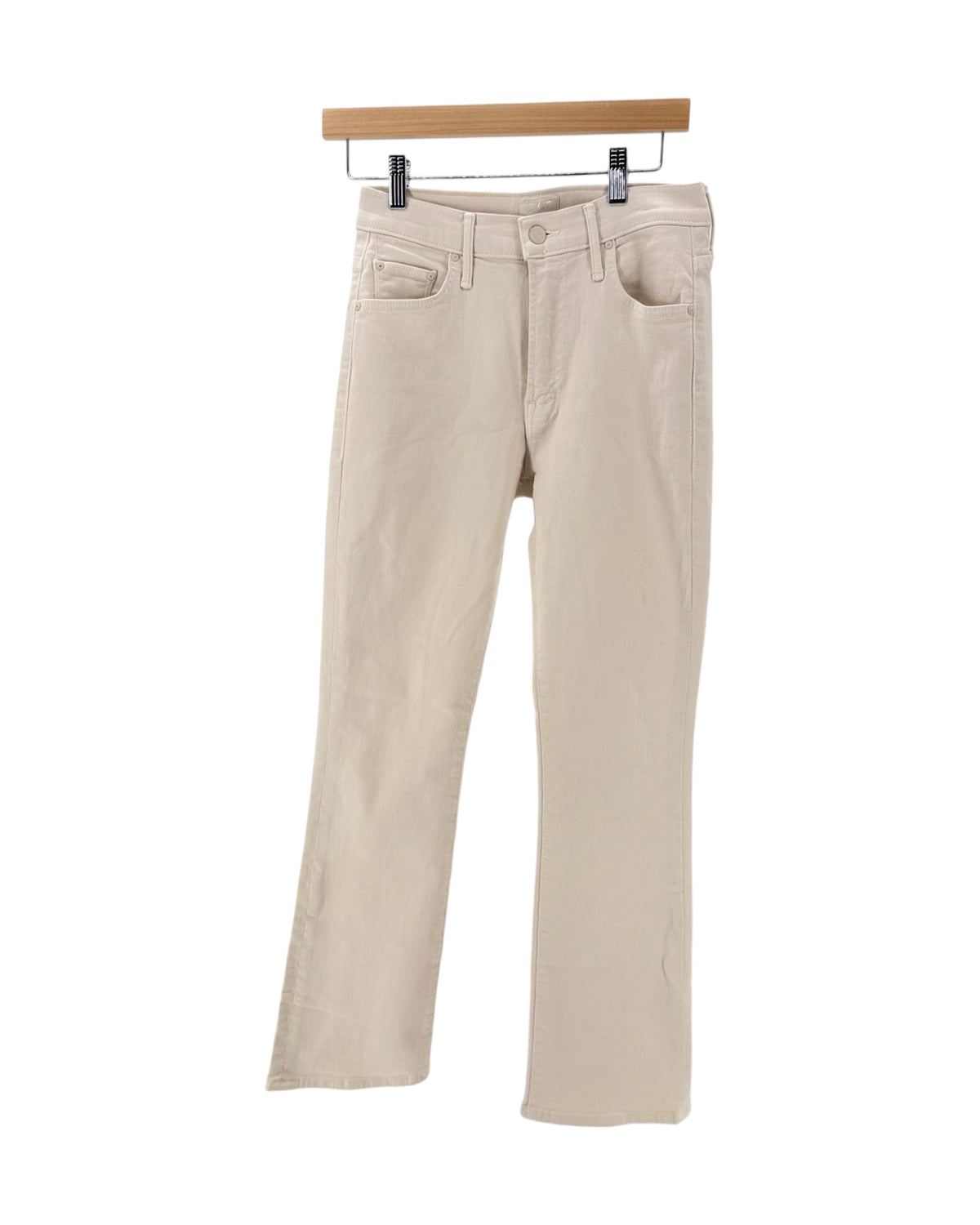 Light beige cream denim jeans on a hanger on a white background