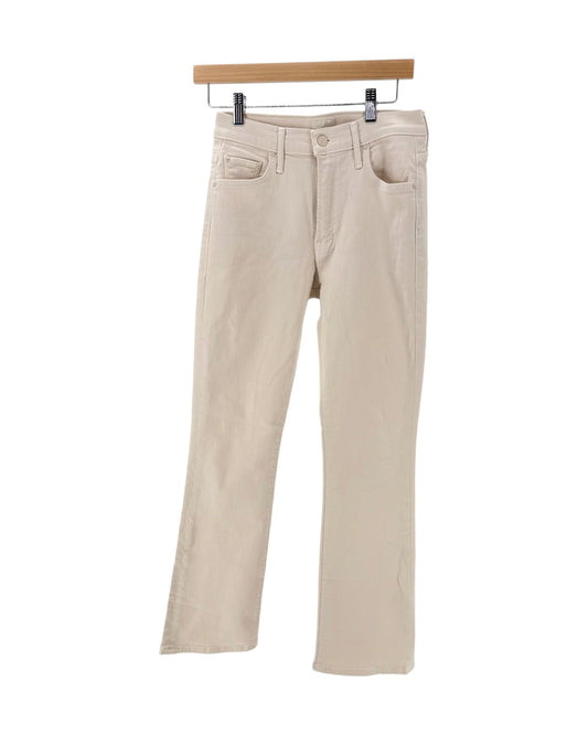 Light beige cream denim jeans on a hanger on a white background