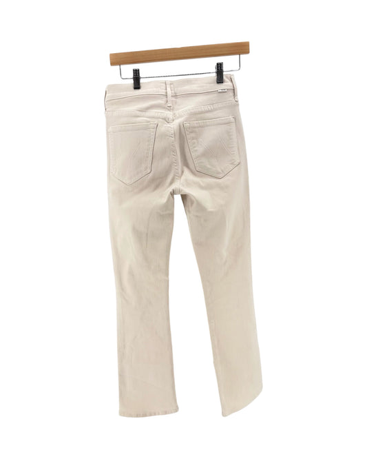 Light beige cream denim jeans on a hanger on a white background